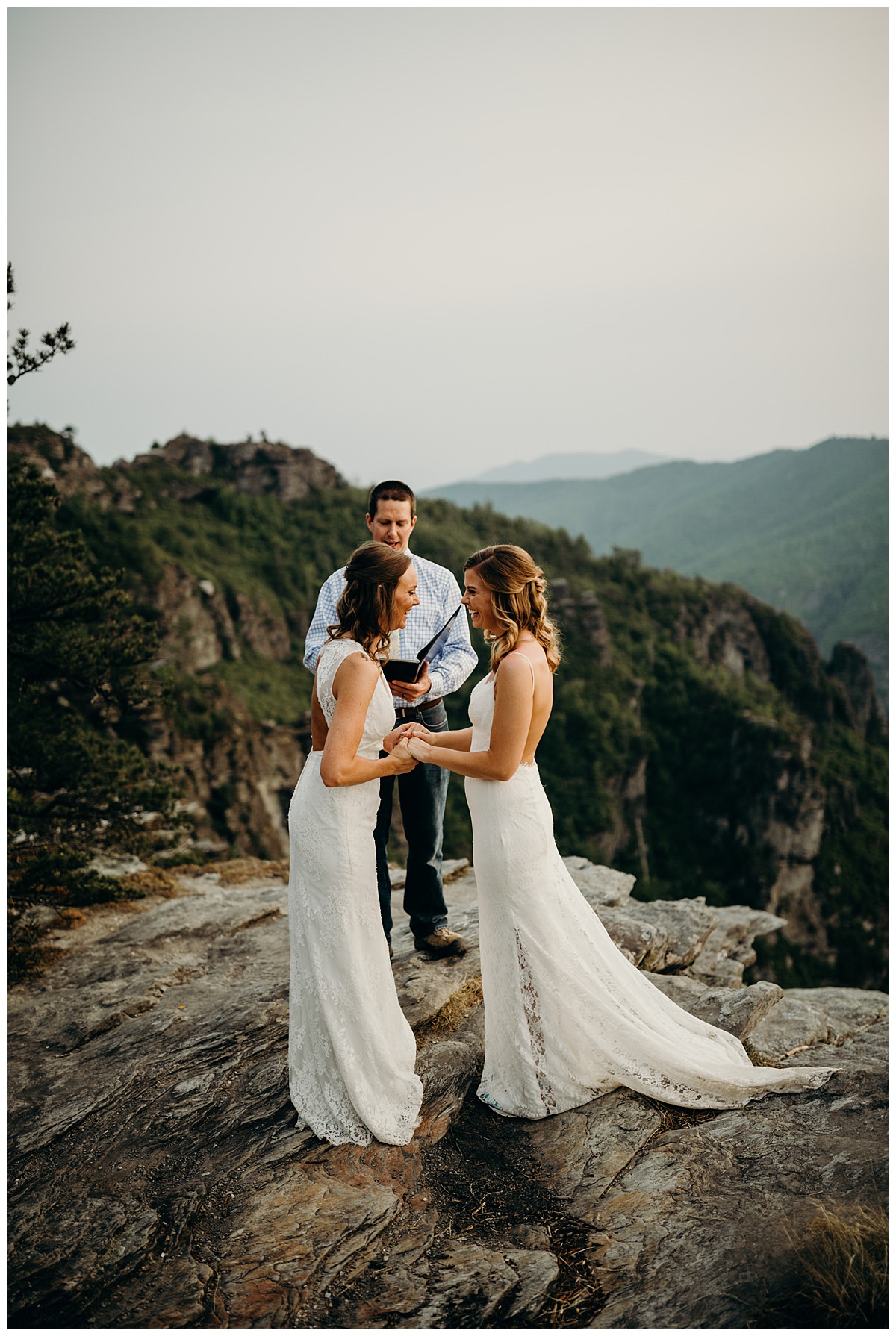 An adventure elopement ceremony at The Chimneys NC with the officiant and two brides.